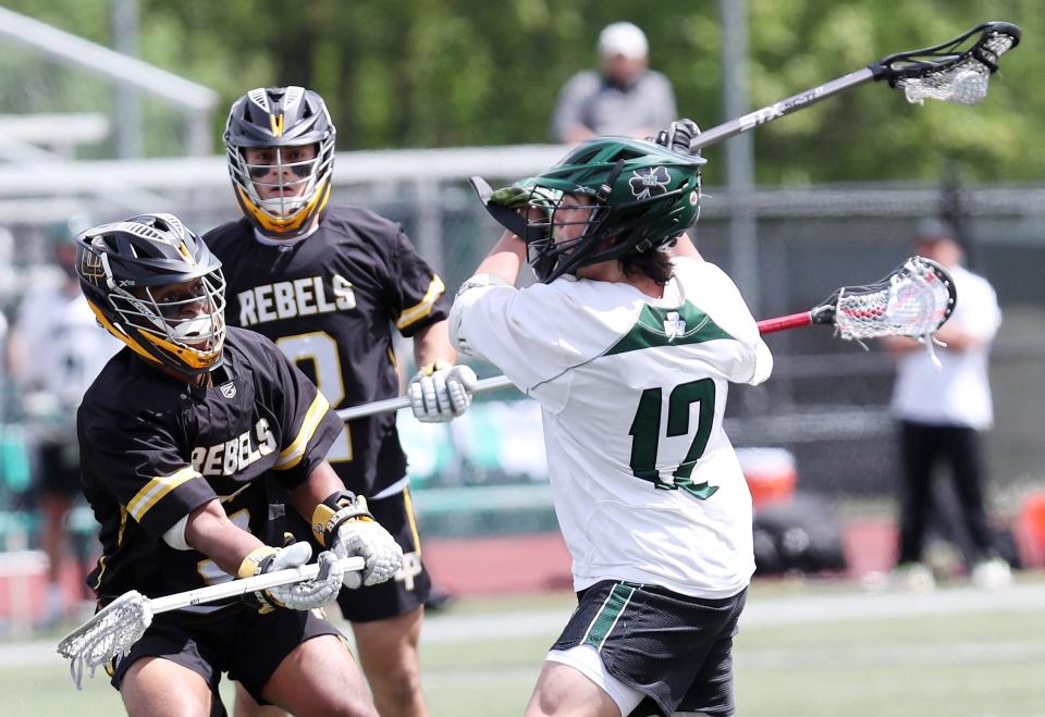 Yorktown's Gianluca Marchini (12) fires a shot against Lakeland-Panas during action in the annual Murphy Cup game at Yorktown High School May 11, 2024. Yorktown won the game 7-5.