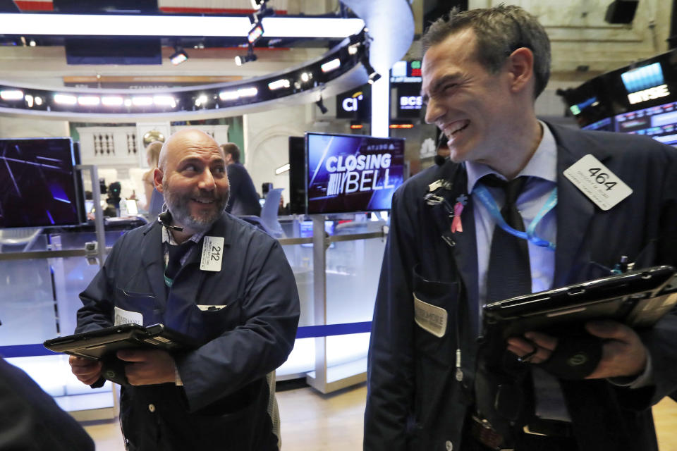 Trader colleagues Vincent Napolitano, left, and Gregory Rowe smile at the close of trading on the floor of the New York Stock Exchange, Wednesday, Nov. 7, 2018. Stocks closed sharply higher on Wall Street as investors are relieved that midterm elections went as they had expected, leaving split control of Congress. (AP Photo/Richard Drew)