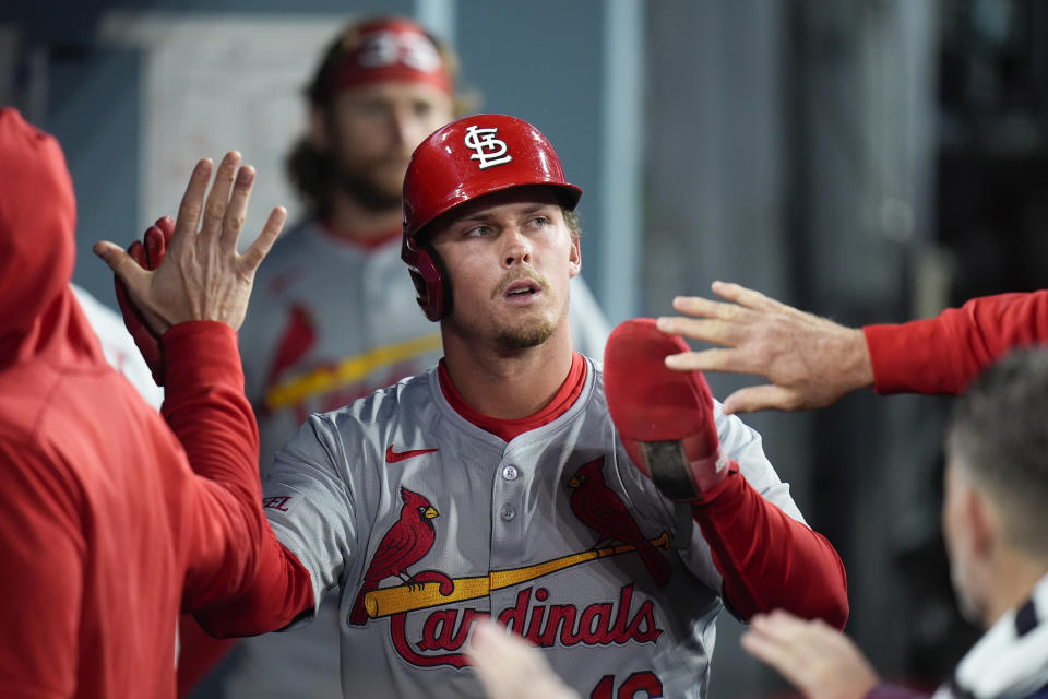St. Louis Cardinals' Nolan Gorman is greeted by teammates after he scored on a sacrifice fly by Ivan Herrera during the seventh inning of a baseball game against the Los Angeles Dodgers Saturday, March 30, 2024, in Los Angeles. (AP Photo/Jae C. Hong)