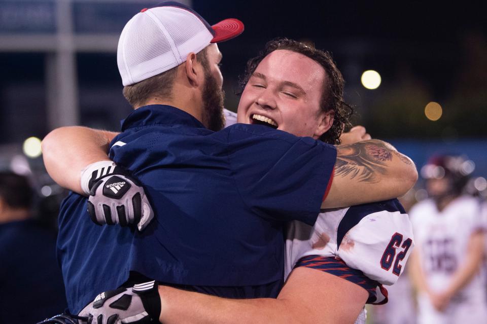 West’s John Sartelle (62) hugs a coach after the BlueCross Bowl Class 5A championship game Dec. 2.