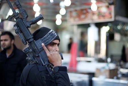 A member of the Iraqi Special Operations Forces (ISOF) stands guard at al Zohour area in Mosul, Iraq, January 23, 2017. REUTERS/Muhammad Hamed