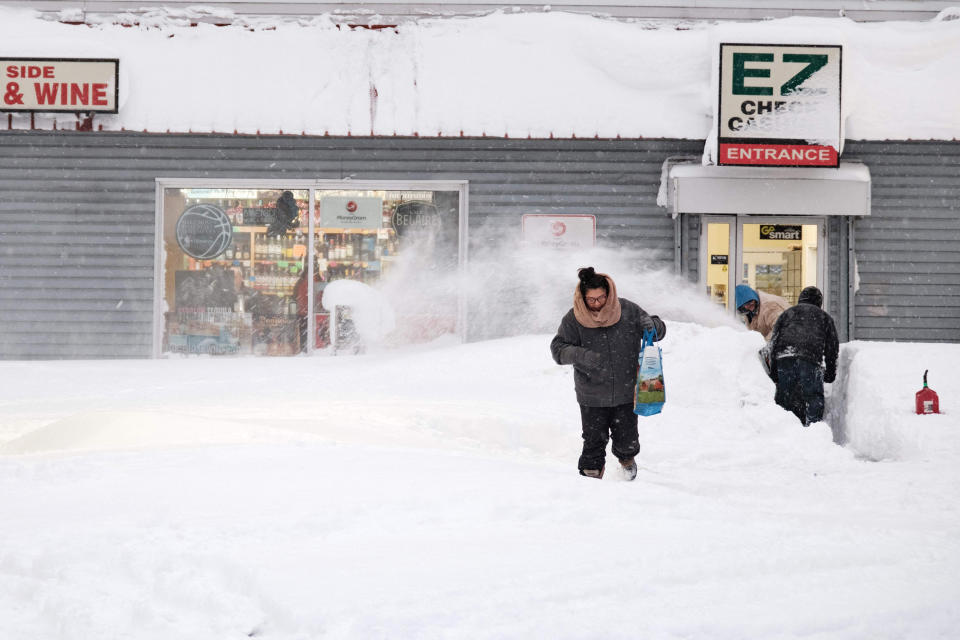 A resident leaves a local corner store in Buffalo, New York, on December 26, 2022, as many major grocery stores remained closed. - Emergency crews in New York were scrambling on December 26, 2022, to rescue marooned residents from what authorities called the 