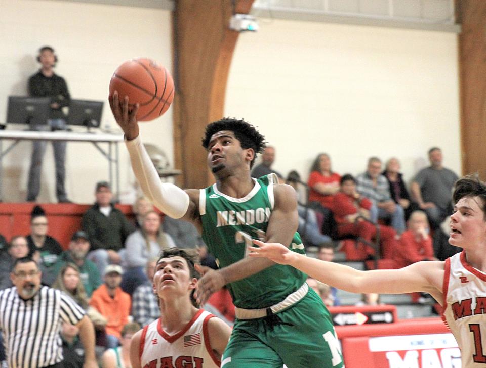 Jack McCaw of Mendon glides in for a layup against Colon in prep hoops action on Tuesday.