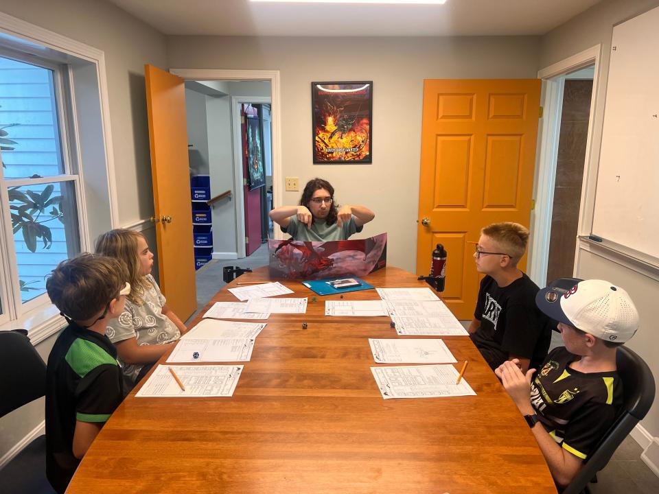 Kids Dungeon and Dragon group in action with brother duos. From left to right: Patrick Darcy, Weston Auclair, Tyler Souza (dungeon master), Grayson Auclair, and Tim Darcy.