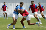 Argentina's Lucio Cinti, right, tackles Franco Sabato during a men's rugby sevens practice at the Tokyo 2020 Olympics, in Tokyo, Friday, July 23, 2021. (AP Photo/David Goldman)