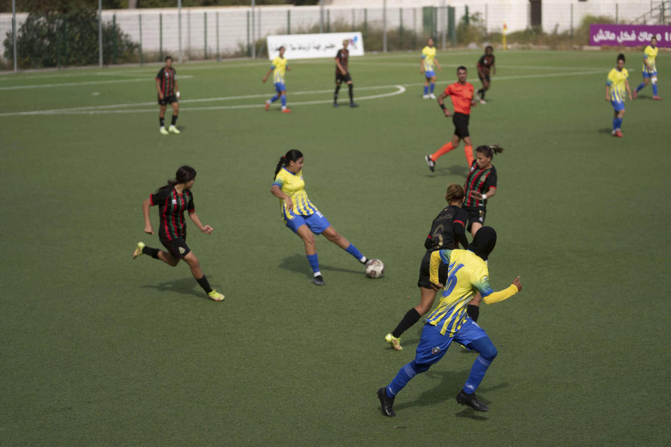 Women footballers compete in a soccer match between ASFAR and ASDCT Ain Atiq, in Morocco's professional women league, in Rabat, Morocco, Wednesday, May 17, 2023. (AP Photo/Mosa'ab Elshamy)