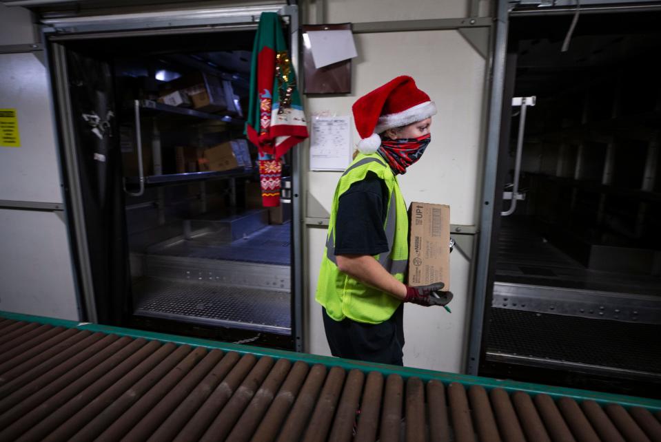 UPS Package handler Amanda Eversole moved boxes to delivery vans at the Louisville hub on Dec. 6, which is considered the peak shipping day of the year.