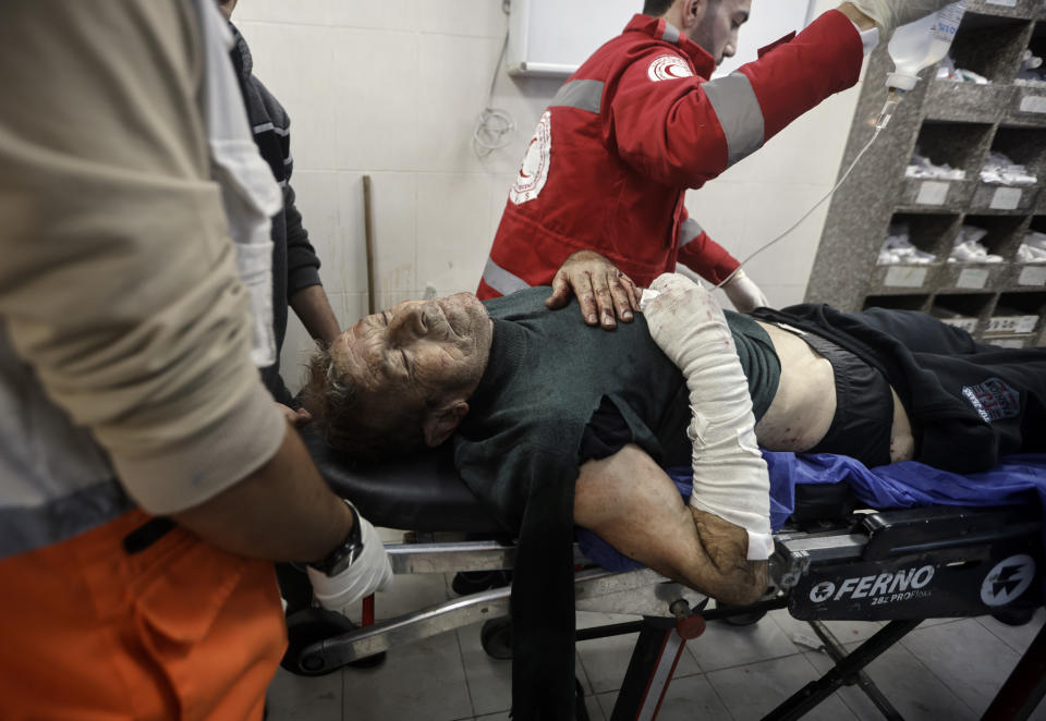 A Palestinian wounded in the Israeli bombardment of the Gaza Strip is brought to the hospital in Khan Younis, Gaza Strip, on Wednesday, Dec. 27, 2023. (AP Photo/Mohammed Dahman)