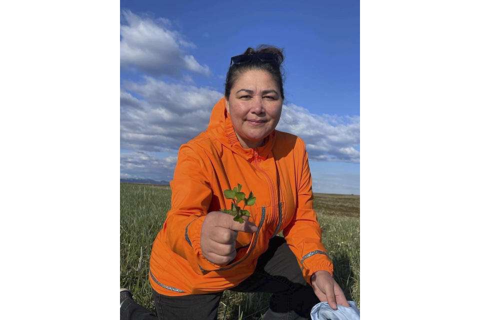 This undated photo shows Alice Bioff wearing an Atmik, a water-proof garment she makes that resembles the traditional Alaska Native garment called a kuspuk in Nome, Alaska. The garment was inspired by a tourist she met in 2016 when she was a tour guide, and she hopes the $600 million expansion of the Port of Nome will translate into support of Nome stores and Indigenous artists. (Alice Bioff via AP)