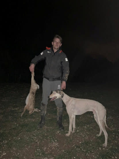 Jimmy Price, 25,  here holding a dead hare, next to a lurcher dog. Jimmy Price was found guilty of taking part in a sick illegal hunting competition that saw entrants win £1,000 in prize money for the winner who could produce evidence of having killed the most hares. (SWNS)