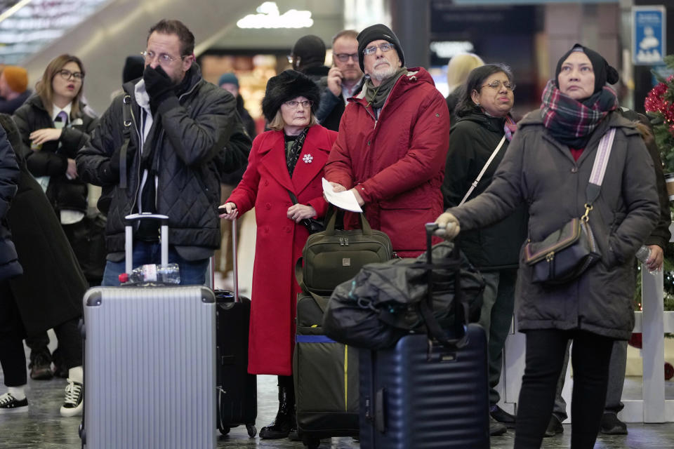 File - Passengers look at the train schedules in the Euston station in London as rail workers stage a strike on Tuesday, Dec. 13, 2022. Consumer prices are rising across Europe and the United Kingdom where public service workers are demanding higher pay as soaring inflation erodes living standards. (AP Photo/Kin Cheung, File)