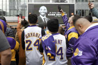 People gather outside Staples Center after the death of Laker legend Kobe Bryant Sunday, Jan. 26, 2020, in Los Angeles. (AP Photo/Michael Owen Baker)