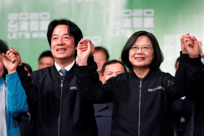 Taiwan Vice President-elect William Lai and incumbent Taiwan President Tsai Ing-wen celebrate at a rally after their election victory, outside the Democratic Progressive Party (DPP) headquarters in Taipei