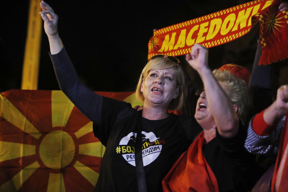 Supporters of a movement for voters to boycott the referendum, celebrate in central Skopje, Macedonia, after election officials gave low turnout figures before polls closed, Sunday, Sept. 30, 2018. The crucial referendum on accepting a deal with Greece to change the country's name to North Macedonia to pave the way for NATO membership attracted tepid voter participation Sunday, a blow to Prime Minister Zoran Zaev's hopes for a strong message of support.(AP Photo/Thanassis Stavrakis)