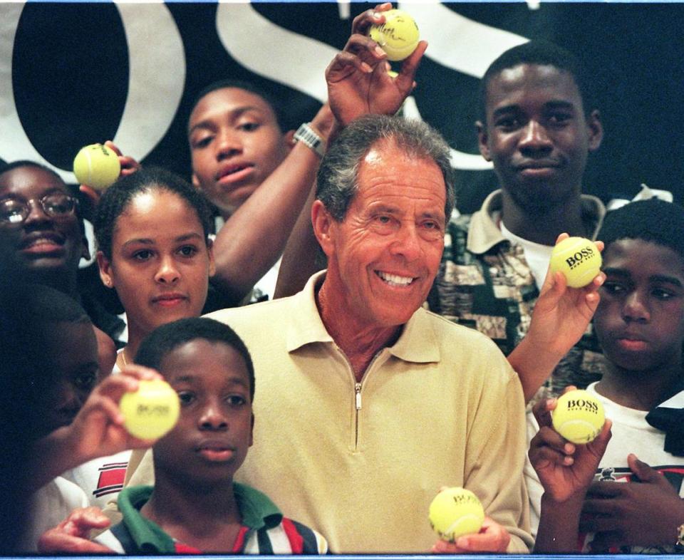 Tennis coach Nick Bollettieri talks to inner city tennis kids in the leadership excellence Training Program on Dec. 11, 1997. The group visited him at a Bloomingdales department store. Al Diaz/Miami Herald file