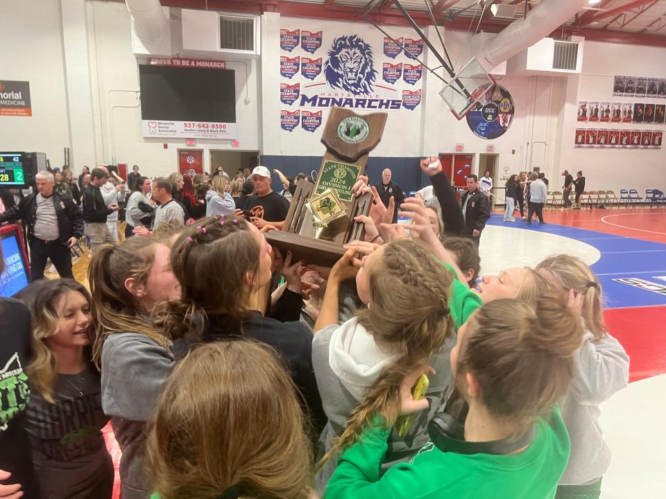 The Harrison High School girls wrestling team celebrates as the girls won the 2024 state duals championship, with a team win over Olentangy Orange in the finals Feb. 10.