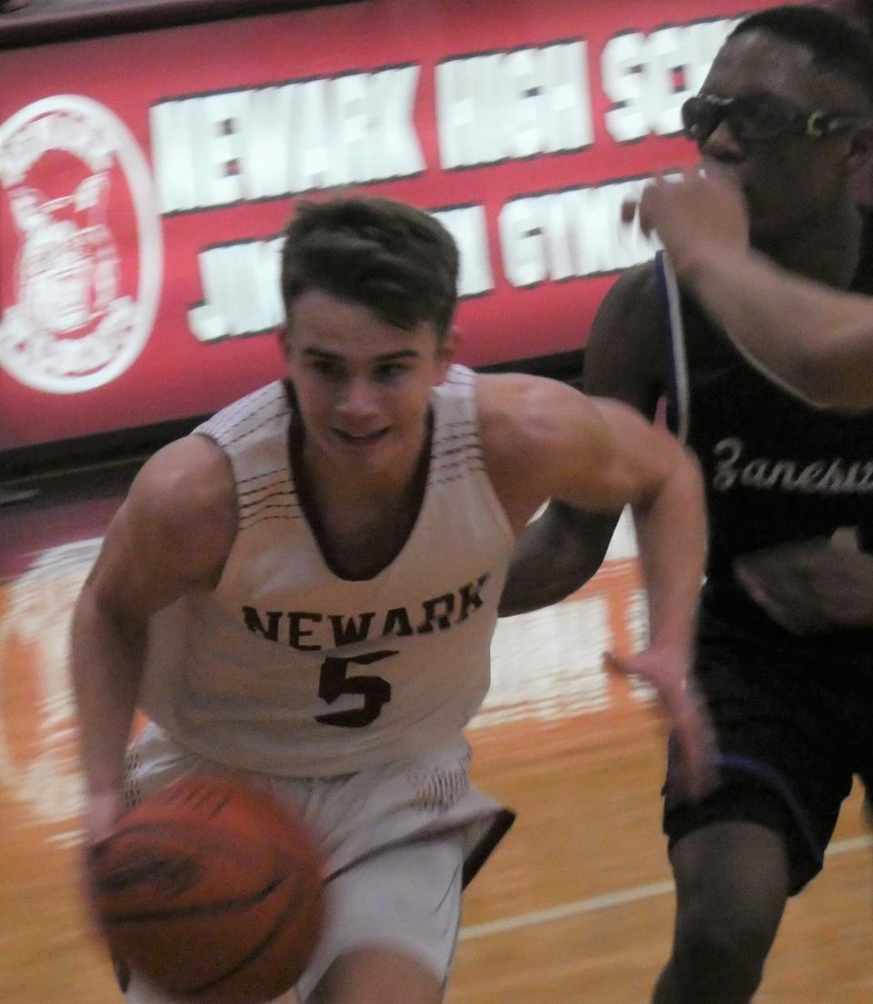 Newark senior Grant Burkholder drives to the basket against rival Zanesville at Jimmy Allen Gymnasium on Saturday, Dec. 3, 2022. Burkholder scored 23 points for the host Wildcats in a 64-29 victory, their 11th consecutive in the rivalry.