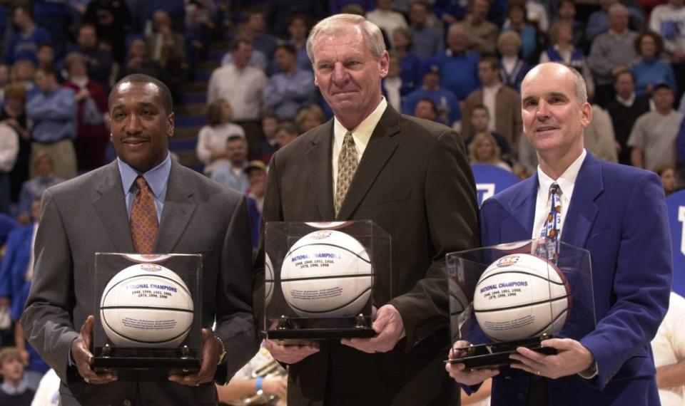 Kentucky basketball greats Jack Givens, left, Dan Issel, center, and Kyle Macy were presented with basketballs as members of the “Fantasy Five” team before a game in Rupp Arena in 2003. Jamal Mashburn and Tony Delk were also named to the team but could not attend due to NBA obligations.
