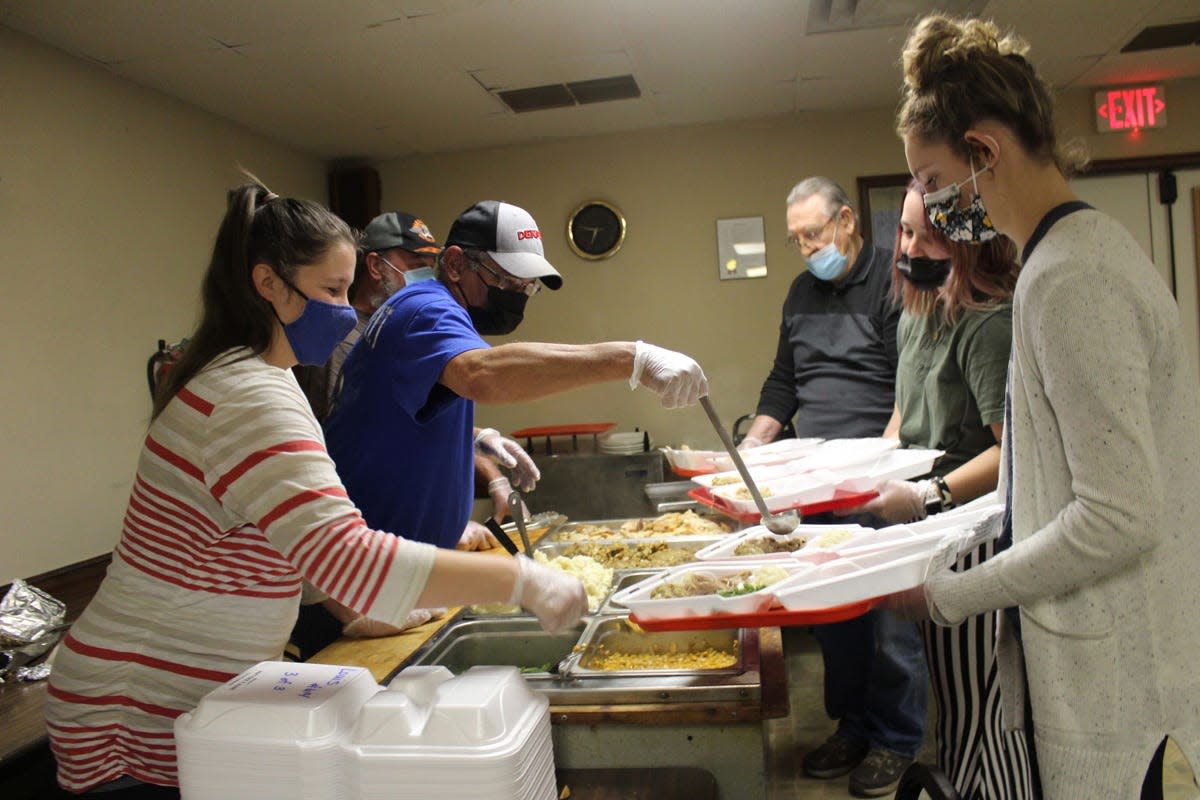 In this file photo volunteers serve Thanksgiving dinner to waiting diners at the Macomb Eagles Club on Thursday. Thanksgiving dinners will again be offered free on Thursday at the Eagles Club in Macomb.