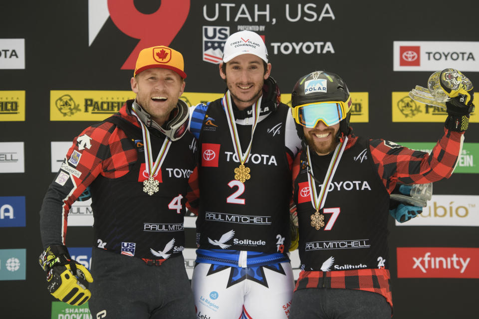 Silver medalist Brady Leman, left, of Canada; gold medalist Francois Place, center, of France; and bronze medalist Kevin Drury, of Canada, celebrate on the podium after the men's ski cross event at the freestyle ski and snowboard world championships Saturday, Feb. 2, 2019, in Solitude, Utah. (AP Photo/Alex Goodlett)