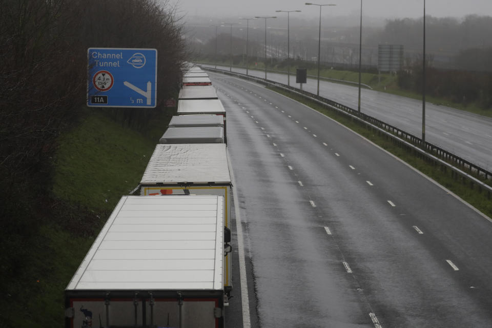 Lorries parked on the M20 near Folkestone, England, Monday, Dec. 21, 2020, as part of Operation Stack after the Port of Dover was closed and access to the Eurotunnel terminal suspended following the French government's announcement. France banned all travel from the UK for 48 hours from midnight Sunday, including trucks carrying freight through the tunnel under the English Channel or from the port of Dover on England's south coast. (AP Photo/Kirsty Wigglesworth)