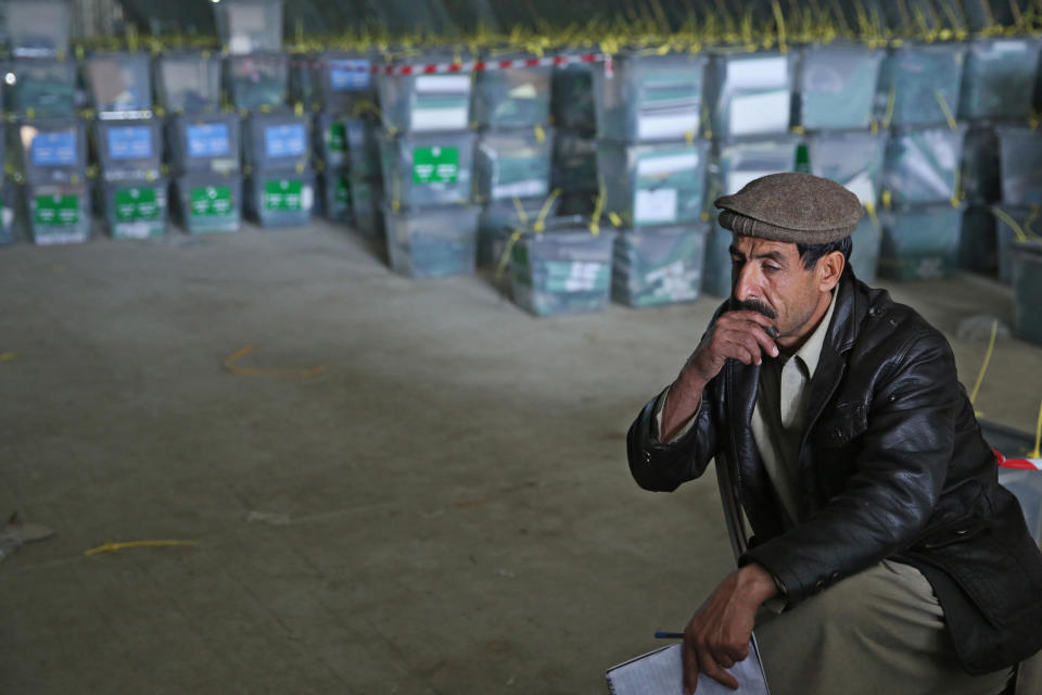 An Afghan election worker rests while working with ballot boxes at a warehouse of the Independent Elections Commission warehouse in Kabul, Afghanistan, Sunday, April 6, 2014. Trucks and donkeys loaded with ballot boxes made their way to counting centers on Sunday as Afghans and the international community sighed with relief that national elections were held without major violence despite a Taliban threat. (AP Photo/Massoud Hossaini)