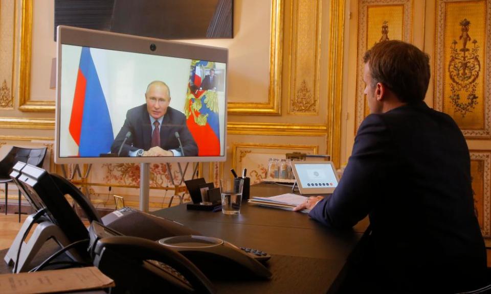 Emmanuel Macron listens to Vladimir Putin during a video call at the Elysée Palace.