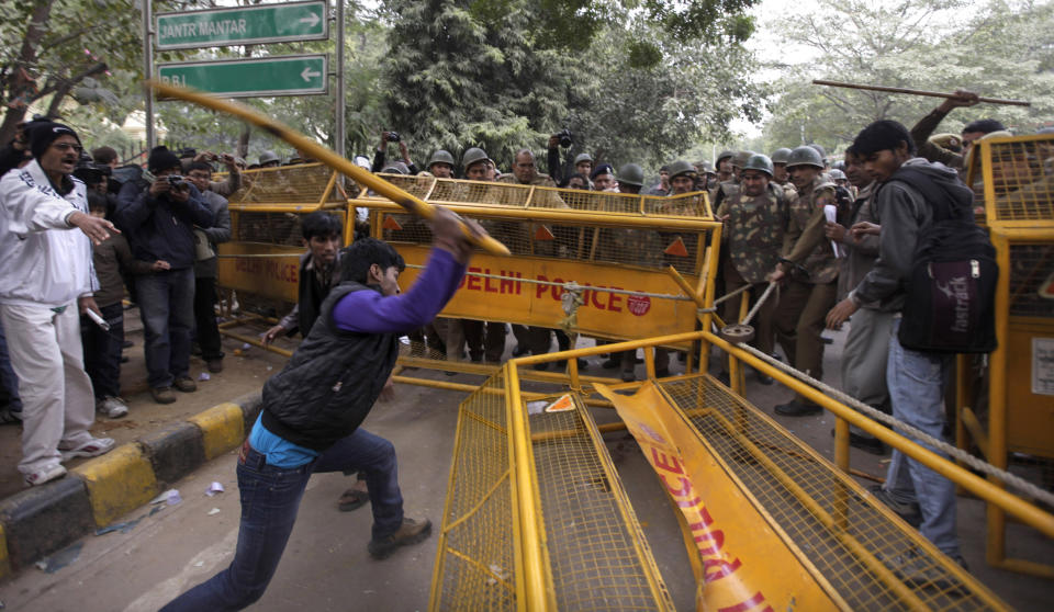 A member of the student wing of Indias main opposition Bharatiya Janata Party vandalizes a police barricade during a protest after the death of a young woman who was recently gang-raped in a moving bus in New Delhi, India, Sunday, Dec. 30, 2012. (AP Photo/Altaf Qadri)