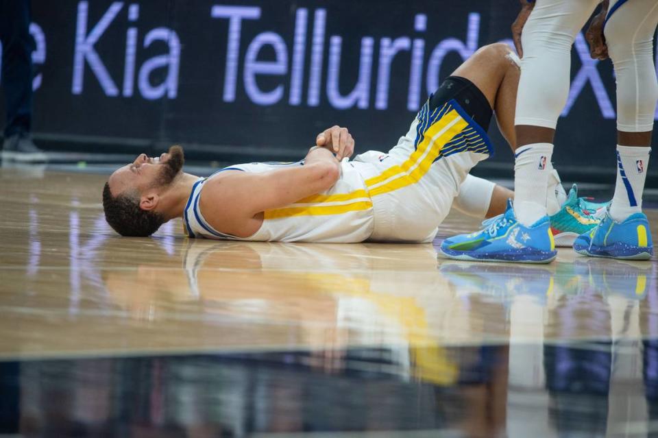 Golden State Warriors guard Stephen Curry (30) lays on gteh ground after he was fouled by Sacramento Kings guard De’Aaron Fox (5) during Game 5 of the first-round NBA playoff series at Golden 1 Center on Wednesday.