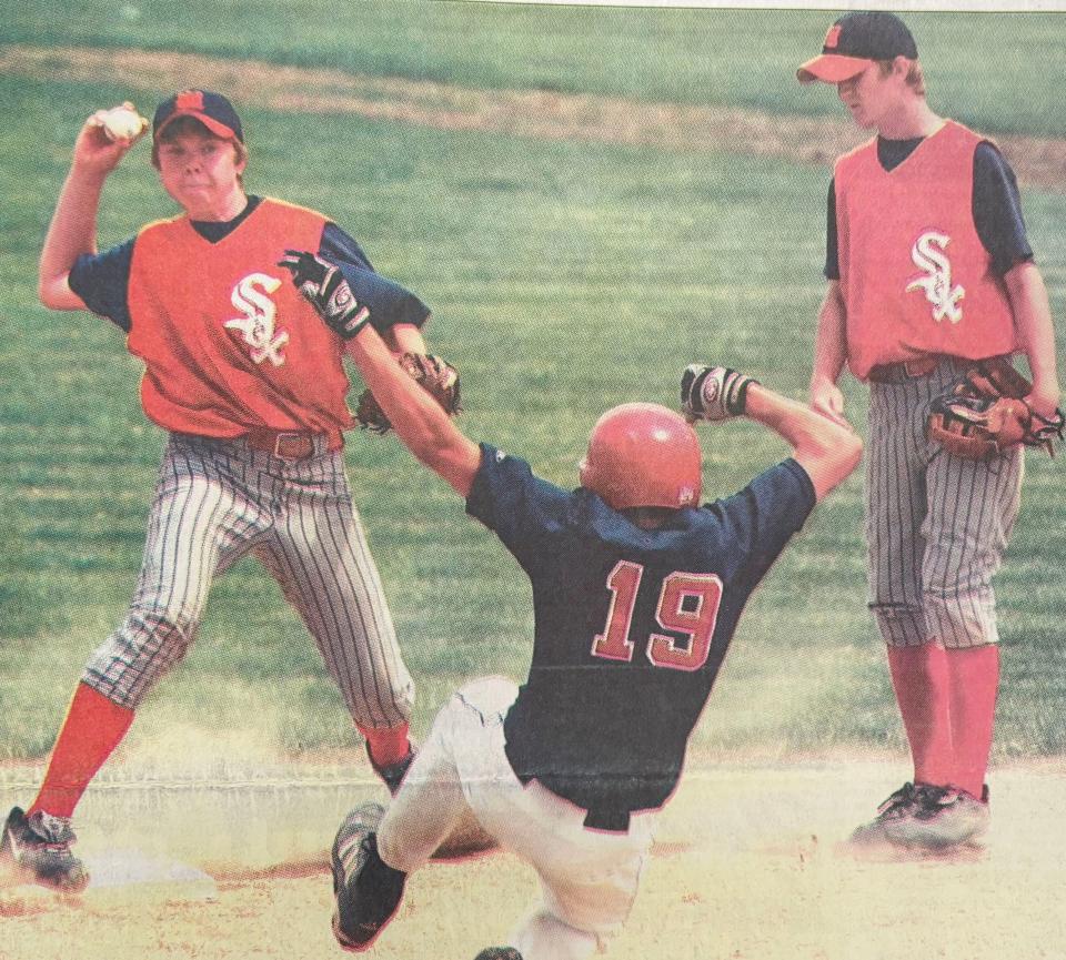 WatertownPost 750 Red Sox shortstop Ryan Schoenefeld throws to first after forcing out a Sioux Falls West base runner during a 2003 VFW Baseball doublehader at Watertown Stadium. At right is second baseman Brett Schoenefeld, Ryan's brother.