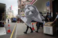 Police officers take away a cardboard featuring the image of Goddess of Democracy from the June 4th Museum as an evidences, in Hong Kong on Sept. 9, 2021. The group, Hong Kong Alliance in Support of Patriotic Democratic Movements of China, that had organized annual vigils in remembrance of victims of the Chinese military’s crushing of the 1989 Tiananmen Square pro-democracy protests voted to disband Saturday, Sept. 25, 2021 amid an ongoing crackdown on independent political activism in the semi-autonomous Chinese city. (AP Photo/Kin Cheung)