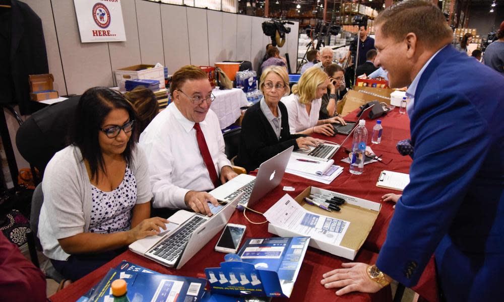 Workers monitor the Republican party table at the Palm Beach county supervisor of elections warehouse.