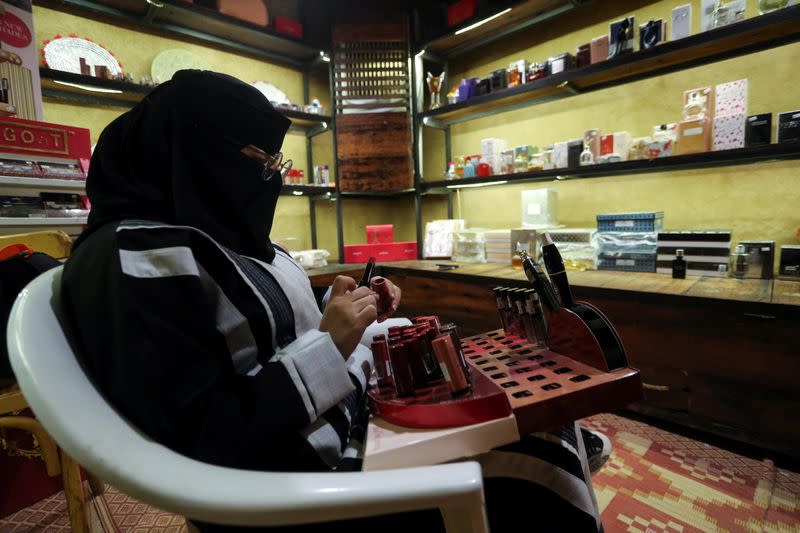 Saudi woman Mada'in al-Balawi works in a cosmetic shop in the old town, in AlUla