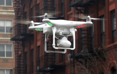 A camera drone operated by a civilian flies near the scene where two buildings were destroyed in an explosion in New York, in this file photo taken March 12, 2014. REUTERS/Mike Segar/Files