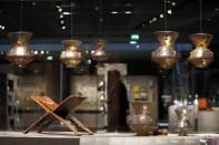 A lectern for Koran (L) and Lamps from Egypt or Syria dating from the 14th century are displayed on September 17, 2012 in Paris, at the new Department of Islamic Arts at the Louvre, the largest of its kind in Europe, with 3,000 artefacts on display, gathered from Spain to India and dating back to the seventh century AD. Intended to celebrate "The Radiant Face of a Great Civilization" the 100-million-euro project - largely financed by donors from across the Islamic world - will be inaugurated by French President ahead of its official opening on September 18. AFP PHOTO / KENZO TRIBOUILLARD