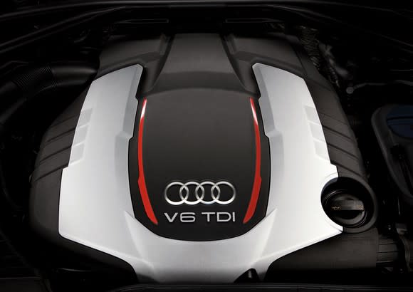 The top of an engine, showing Audi's four-rings logo and 