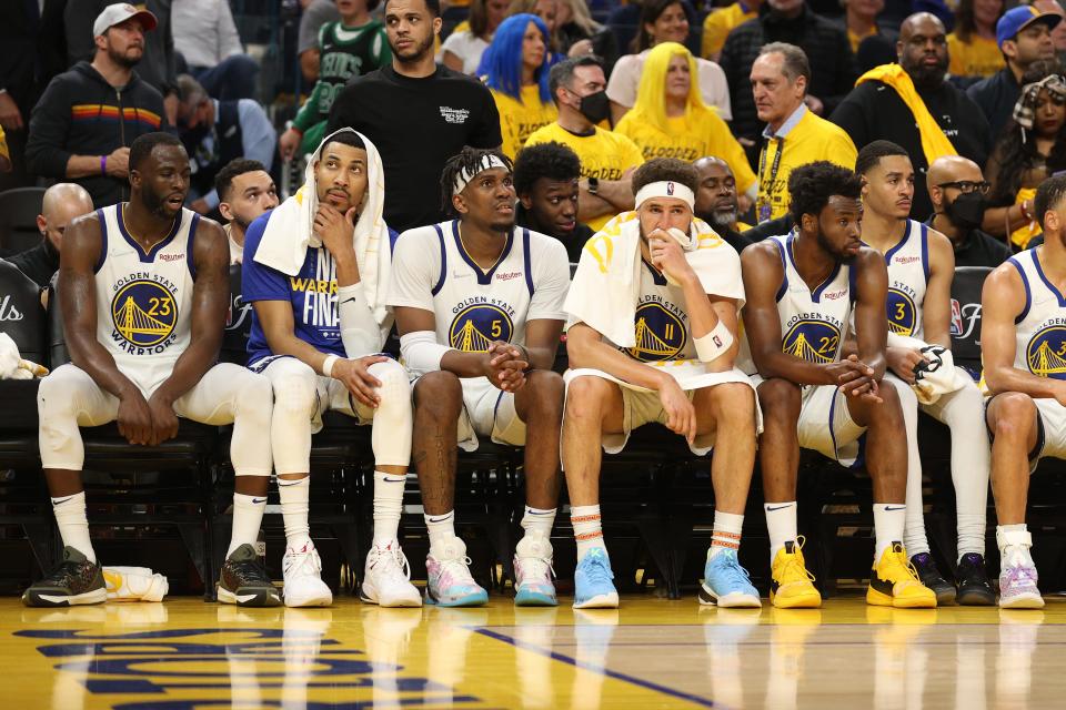 (L to R) Draymond Green, Otto Porter Jr., Kevon Looney, Klay Thompson, Andrew Wiggins and Jordan Poole of the Golden State Warriors look on from the bench during the fourth quarter against the Boston Celtics in Game One of the 2022 NBA Finals at Chase Center on June 02, 2022 in San Francisco, California.