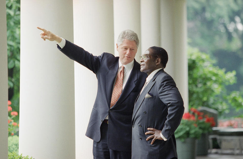 FILE - In this Thursday, May 18, 1995, file photo, President Bill Clinton gestures while talking to Zimbabwe's Prime Minister Robert Mugabe in the Colonnades of the White House, Washington. Mugabe, the longtime leader of Zimbabwe who was forced to resign in 2017 after a military takeover, has died at 95. (AP Photo/Greg Gibson, file)