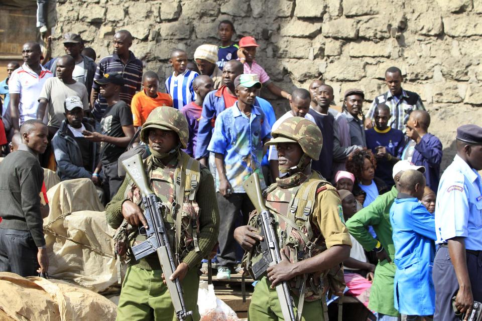 Kenyan policemen keep guard at the scene of a twin explosion at the Gikomba open-air market for second-hand clothes in Kenya's capital Nairobi May 16, 2014. (REUTERS/Noor Khamis)