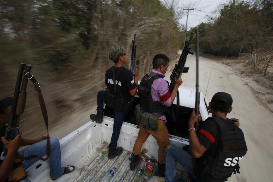 FILE - In this May 29, 2019 file photo, members of a FUPCEG vigilante group patrol in Xaltianguis, Guerrero state, Mexico. President Andres Manuel Lopez Obrador said Thursday, Aug. 22, that he disagreed with his assistant interior secretary’s decision to attend a ceremony with vigilantes, who often call themselves “self-defense” groups. “We cannot have illegal groups performing law enforcement duties. That cannot be allowed,” Lopez Obrador said. (AP Photo/Rebecca Blackwell, File)