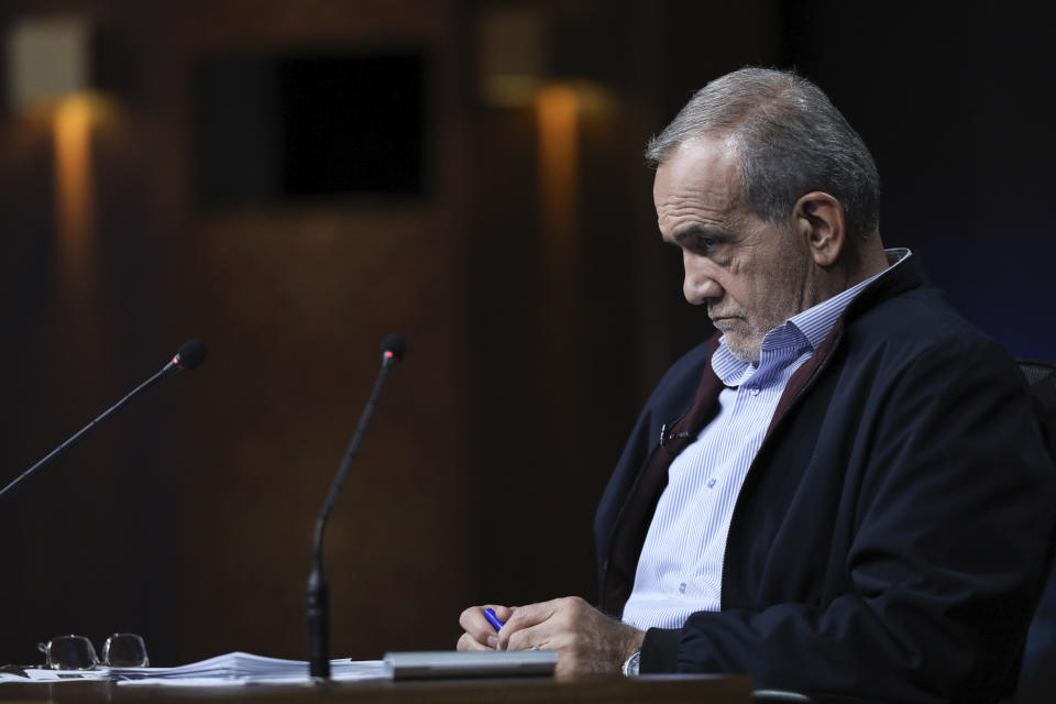 In this photo made available by Iranian state-run TV, IRIB, Iranian presidential candidate reformist Masoud Pezeshkian listens during a debate with hard-line candidate Saeed Jalili at the TV studio in Tehran, Iran, Monday, June 1, 2024. (Morteza Fakhri Nezhad/IRIB via AP)