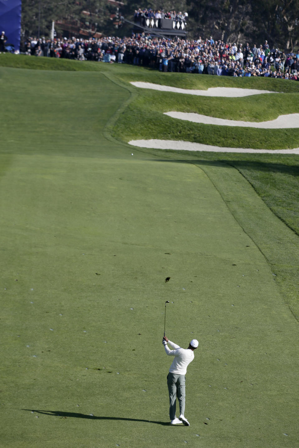 Tiger Woods hits uphill onto the 13th green on the Torrey Pines South Course during the second round of The Farmers Insurance golf tournament in San Diego, Friday, Jan. 24, 2020. (AP Photo/Alex Gallardo)