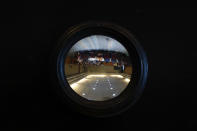 In this Feb. 12, 2020 photo, members of the group "A Tu Encuentro", a collective looking for missing relatives, are seen inverted through a glass window during a private meeting with Mayor Ricardo Ortiz, in Irapuato, Guanajuato state, Mexico. In the last week of January the government said Guanajuato, which has around 5% of Mexico's population, suffered 20% of its homicides. (AP Photo/Rebecca Blackwell)