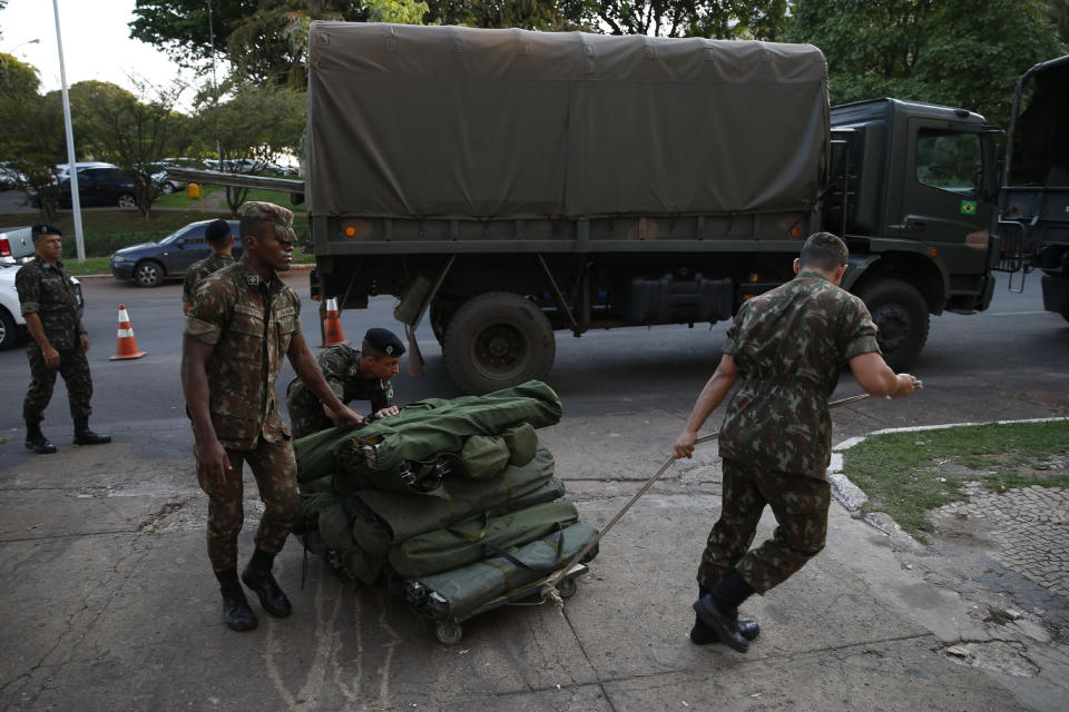 Brazilian army soldiers prepare a security base prior the 11th edition of the BRICS Summit, at the Itamaraty Palace in Brasilia, Brazil, Tuesday, Nov. 12, 2019. The BRICS Summit gathers the group of countries formed by Brazil, Russia, India, China and South Africa, which will take place in the 13th and 14th of this month. (AP Photo/Eraldo Peres)