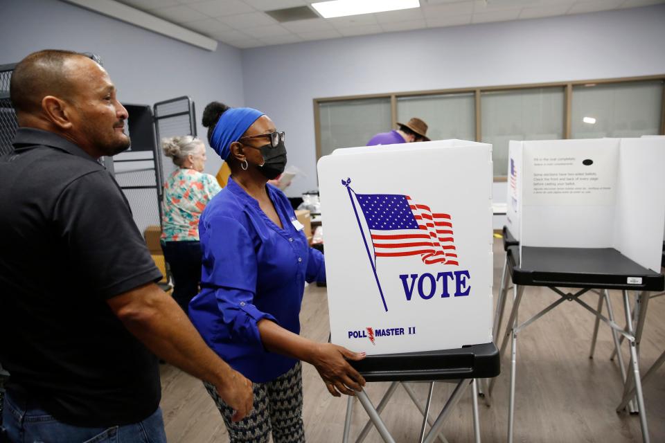 Supervisor of Elections volunteers Fred Burgos, left, and Jessie Finlayson work to assemble voting booths at the Robert L. Gilder Elections Service Center on Aug. 5 in Tampa, Fla. Early voting in Florida started on Aug. 8 and ends on Sunday.