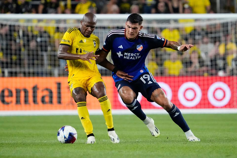 Crew midfielder Darlington Nagbe, left, fights for the ball with FC Cincinnati forward Brandon Vazquez. Columbus would go on to win the game 3-0.