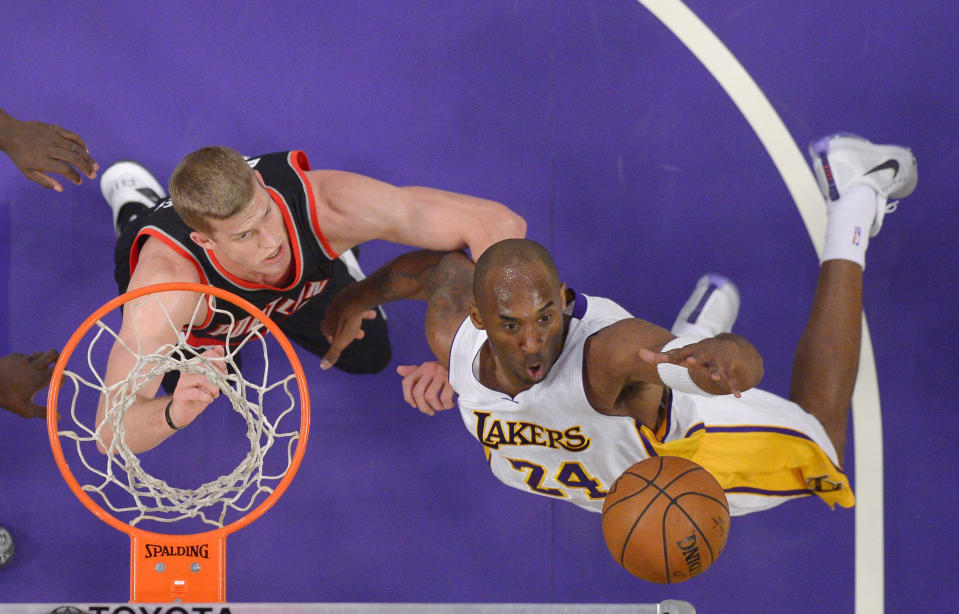 Los Angeles Lakers forward Kobe Bryant, right, grabs a rebound away from Portland Trail Blazers center Mason Plumlee during the first half of an NBA basketball game, Sunday, Nov. 22, 2015, in Los Angeles. (AP Photo/Mark J. Terrill)