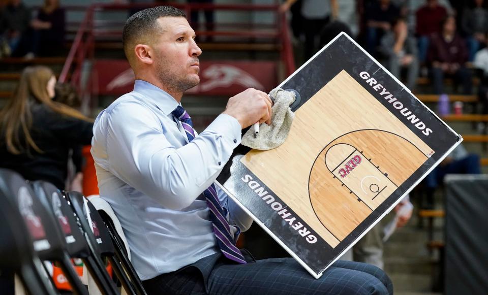 University of Indianapolis Greyhounds head coach Paul Corsaro cleans off a board during half-time Tuesday, Feb.16, 2023 at Nicoson Hall in Indianapolis. University of Indianapolis Greyhounds defeated the Drury Panthers, 76-65. 
