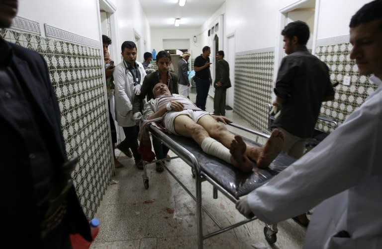 Medics transport an injured Yemeni man on a gurney at a hospital in Sanaa, after he was injured when two suicide bombers hit a Shiite mosque in quick succession on September 2, 2015