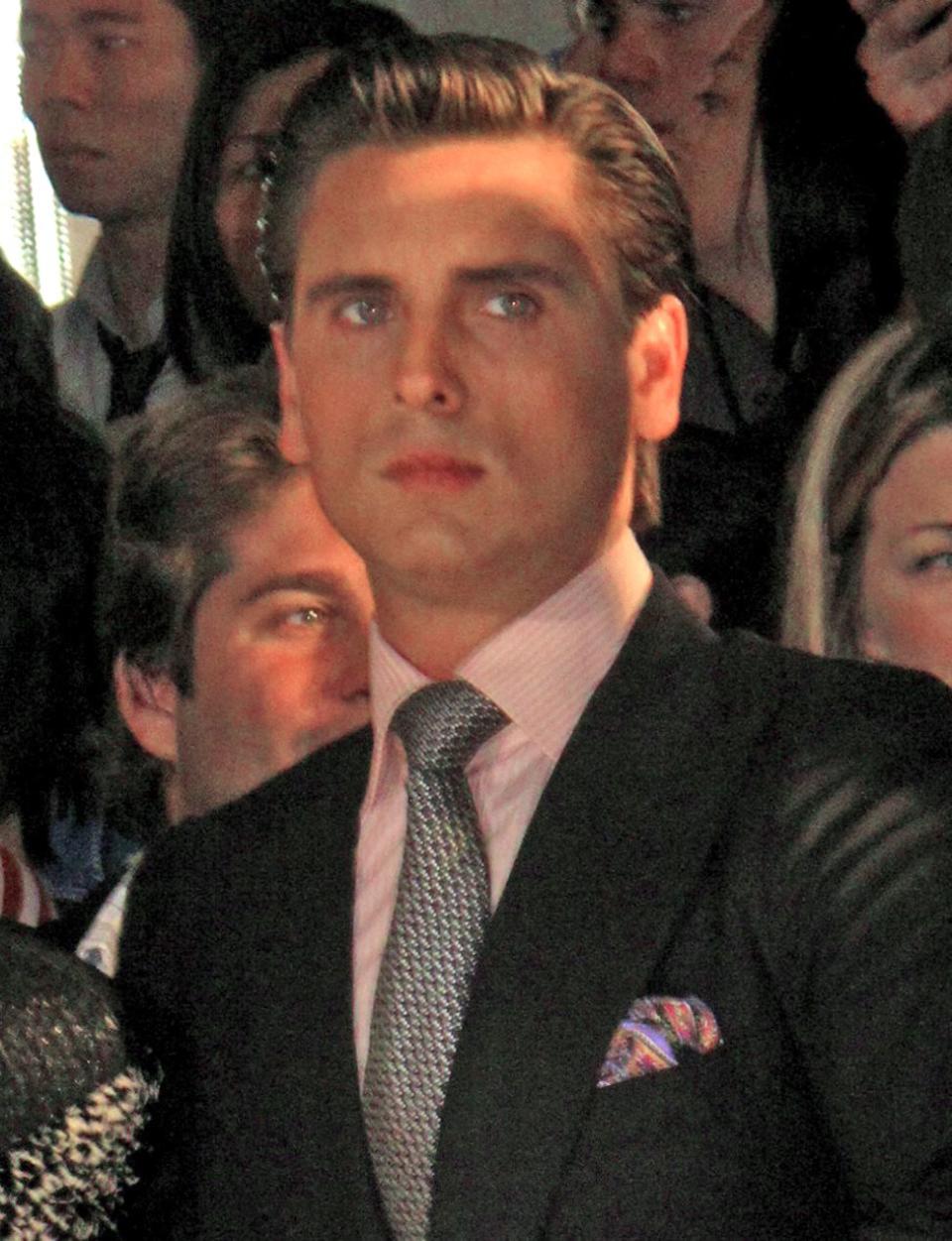 A hilarious photo of Scott Disick in black suit with pink inner T-shirt and tie to match